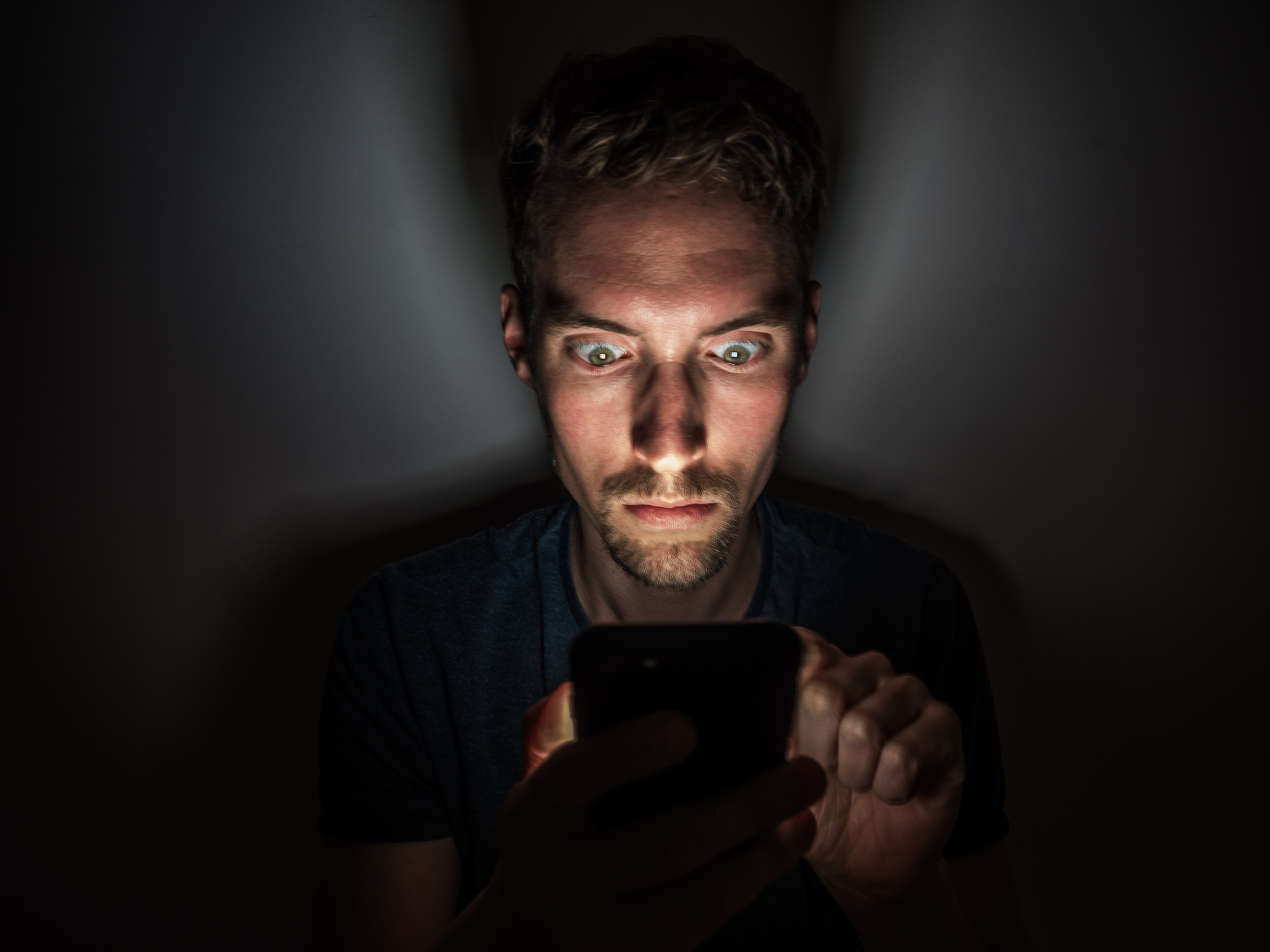 Man on phone in dark room